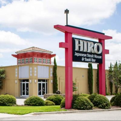 The restaurant sign in front of the building.