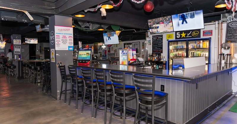 Interior, bar area, stools, checkout counter, fridges and drink shelves in the back