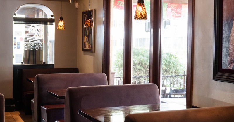 Interior of a restaurant with booths, and large windows