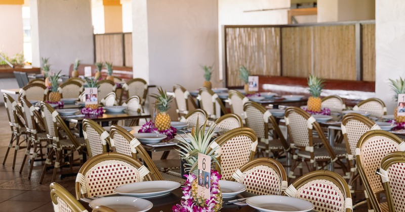 Indoor dining area with neatly arranged tables set for an event meal