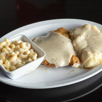 Chicken fried steak served with country gravy and macaroni and cheese.
