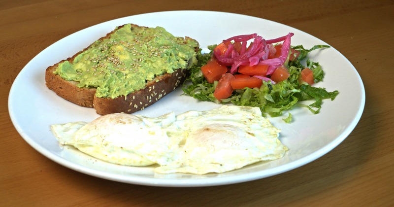 Avocado toast with eggs and salad on the side