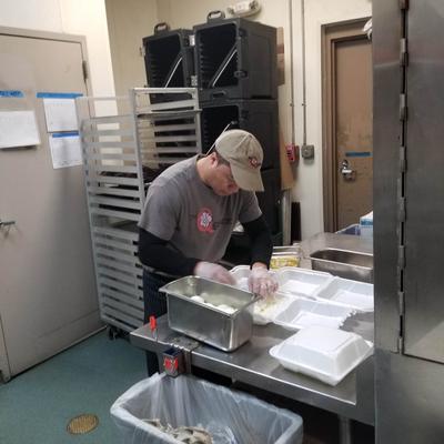 A staff member working in the kitchen.