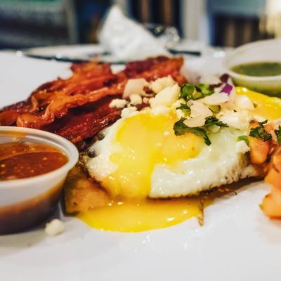 Fried egg with bacon and sauce