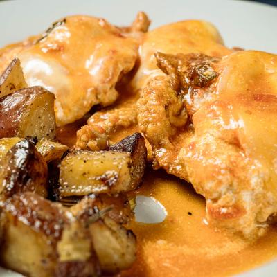 Egg battered veal topped with prosciutto.