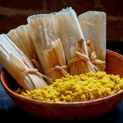 Tamales with yellow rice.