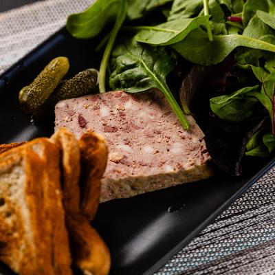 Mixed meat spread, with salad, and toast.