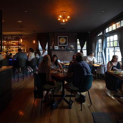People dining in a warmly lit restaurant.