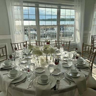 Fully set large dining table by the window.