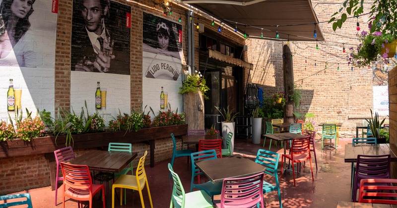 Exterior, partially covered patio with chairs and tables