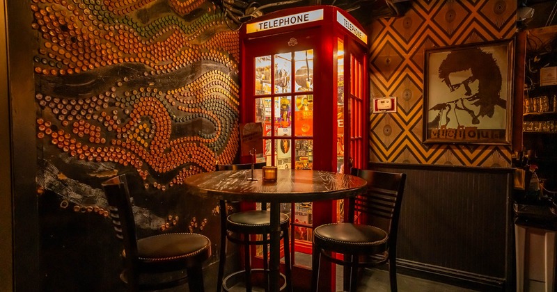 Decorated Interior, bar table and stools, phone booth in the back