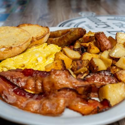 Bacon, eggs, sausages, potatoes, and biscuits.