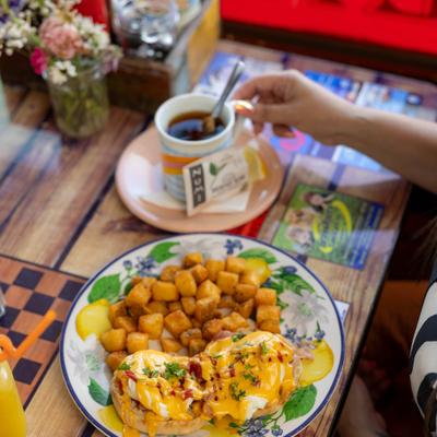 Eggs Benedict with breakfast potatoes and tea.