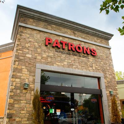 Facade of a stone building featuring PATRON'S Mexican Bar & Grill in bold red letters.
