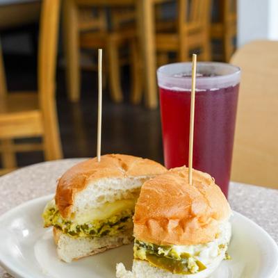 Josie's sandwich, sliced in half and served with a drink.