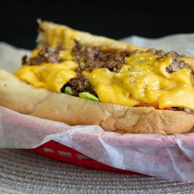 Cheesesteak sandwich with melted cheese on a hoagie roll.