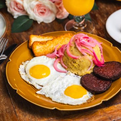 Mashed green plantains, onion, fried cheese, salami and two sunny side eggs.