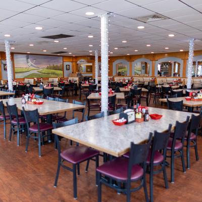 Interior of a spacious dining area with tables ready for guests.