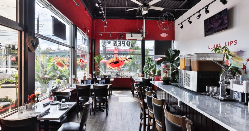Interior, dining area and bar area, dining tables lined up by the windows near the bar