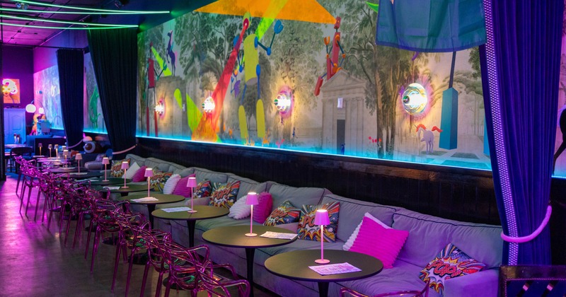 Interior, seating area, long over the wall banquette sofa with tables and chairs