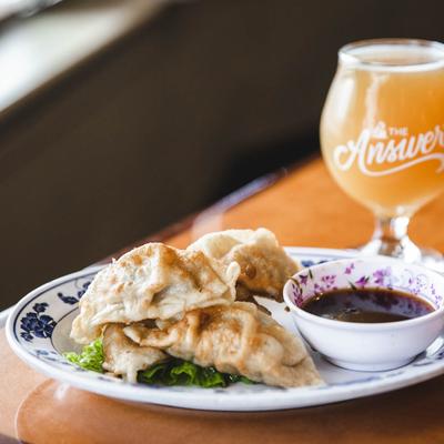 Fried dumplings with a dipping sauce, served with IPA.
