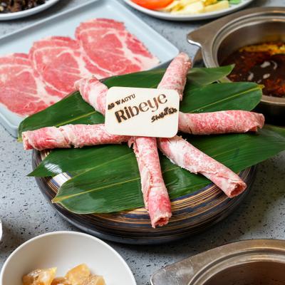 Thinly sliced Wagyu ribeye beef prepared for a Japanese hot pot dish.