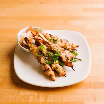 Grilled chicken skewers with pickled vegetables.
