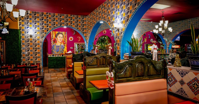 Interior seating area with double booths, chairs and tables, traditional Mexican decoration