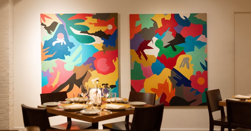 Interior, modern elegant dining space with big paintings