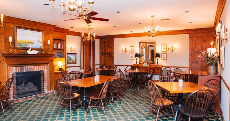 Interior, tables and chairs near fireplace in the room