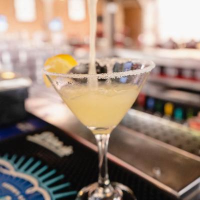 Lemon Drop Martini being strained into a sugar-rimmed glass.
