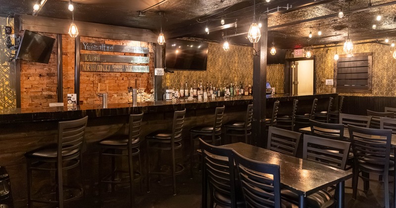 Interior, tables and chairs near bar
