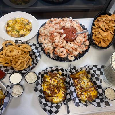 An assortment of dishes arranged on a buffet table, top view.