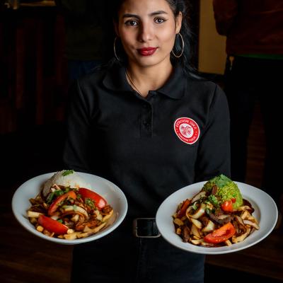 A staff member holding meals.