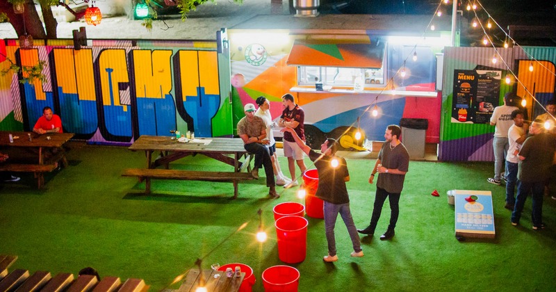 People playing cornhole