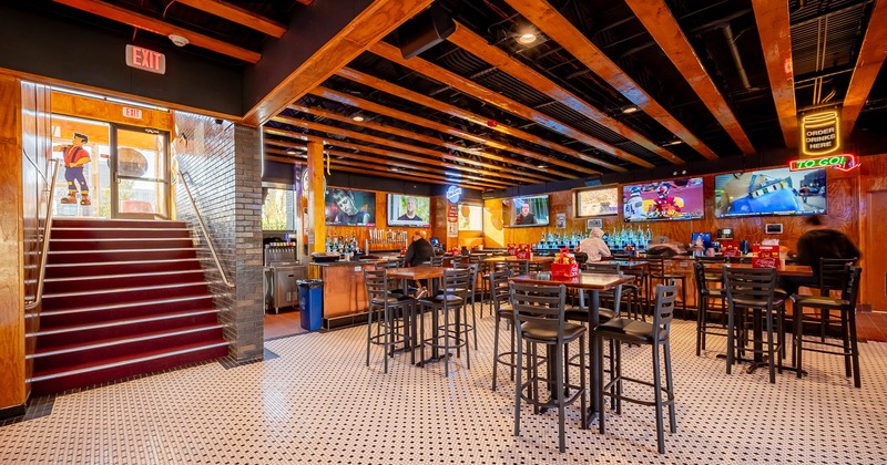 Interior, basement with bar tables and bar stools