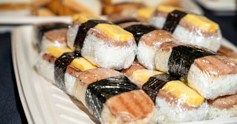 Tray of sushi rice sandwiches, close up
