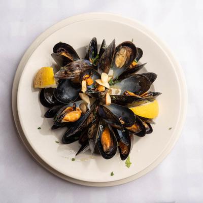 Mussels served in cracked pepper and lemon broth.