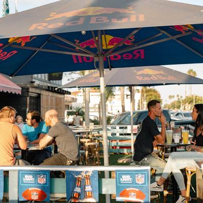 Guests dining on the patio under umbrellas