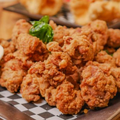 Popcorn chicken garnished with herbs, close-up.