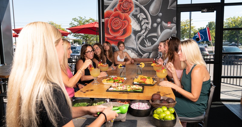 Exterior, guests enjoying food and drinks at table