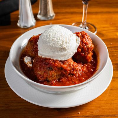 Meatballs in red sauce, with ricotta cheese.