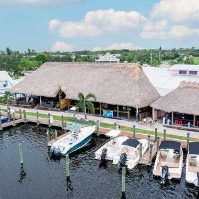 Aerial view of a waterfront bar and marina with boats.