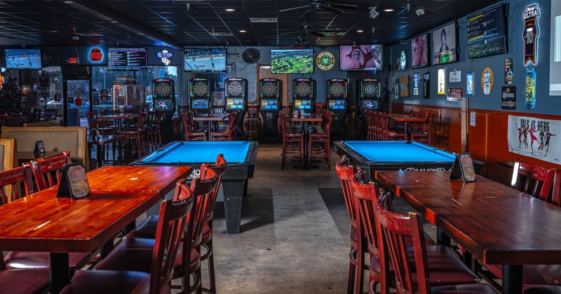 Interior, seating and game area, pool tables, darts, high wooden tables with stools