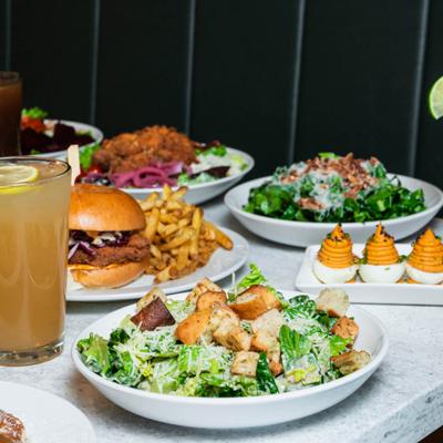 A vibrant table spread of colorful dishes and drinks.