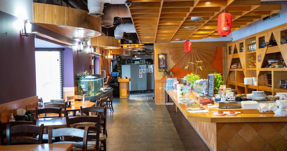 Diner area, tables, chairs, food counter. wide view
