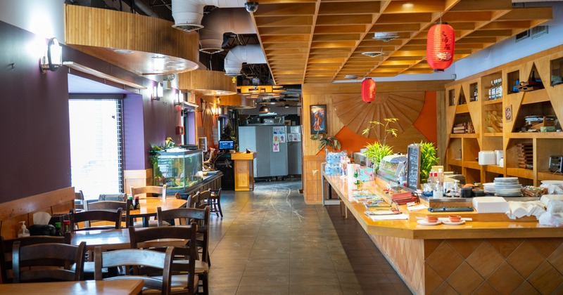 Diner area, tables, chairs, food counter. wide view