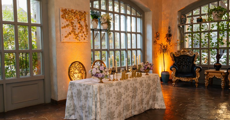 Interior, event space, newlywed's table, Mr. and Mrs. signs, large arched windows