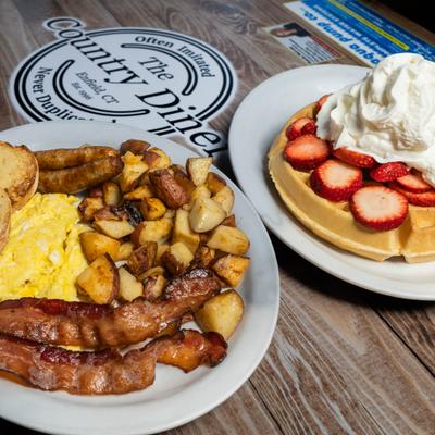 Breakfast platter and a waffle.