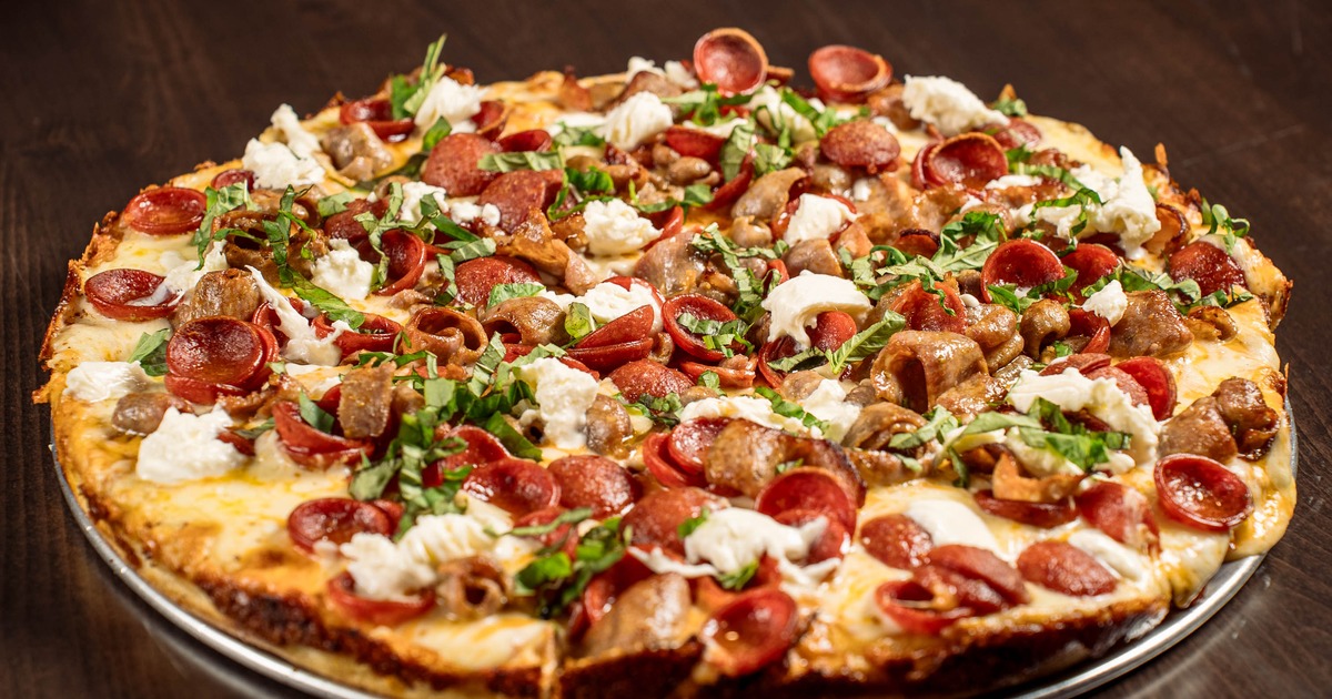 Whole Show Stopper pizza served on a metal tray
